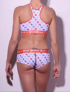 GG Ginch Gonch Hardball boy cut Brief cheeky gogo - women's Underwear - pin striped white fabric with basketballs, footballs, soccer balls, tennis balls, and baseballs. Orange trim with orange printed waistband back shown with matching sports bra