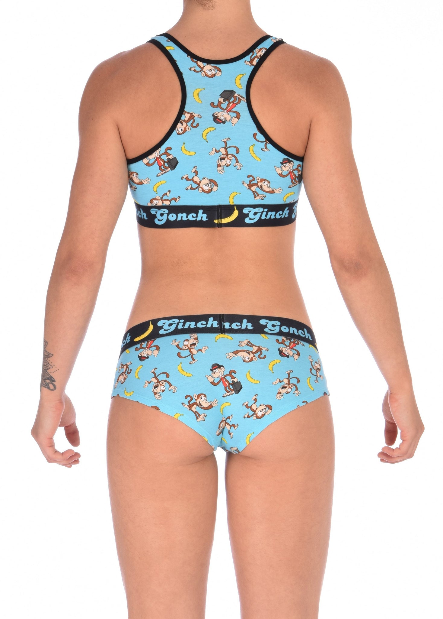 Ginch Gonch Monkey Business Women's Underwear boy cut brief, gogo, with blue background, monkeys, and bananas. Black trim and printed waistband with Ginch Gonch and bananas. Back. With matching sports bra.